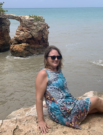 reviewer showcasing the dress at the beach