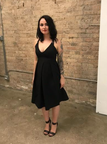 reviewer wearing the dress at a party, paired with sleek black heels