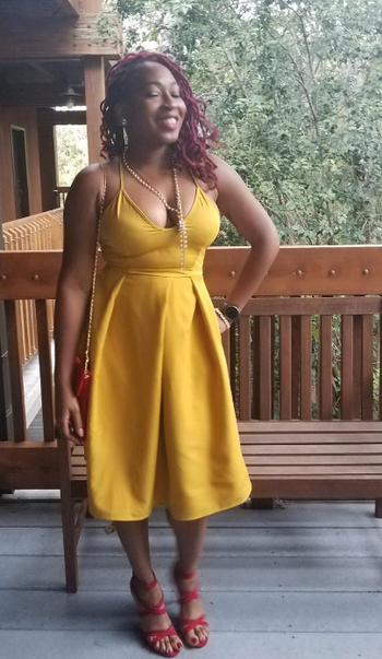 reviewer showcasing the dress in a vibrant yellow hue