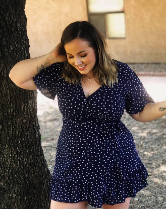 reviewer modeling the dress in a striking blue shade