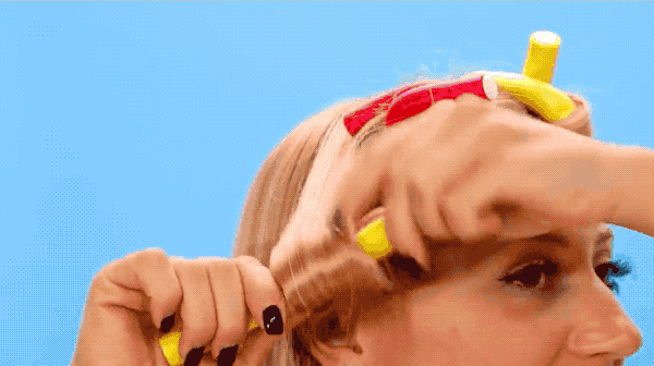 a gif demonstrating a model applying the curling rods