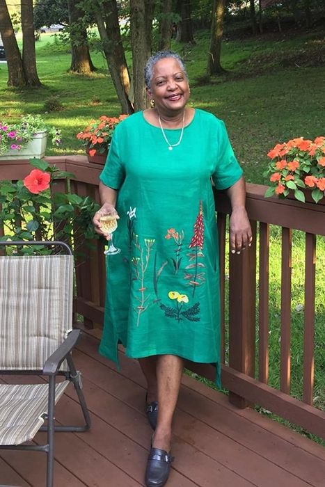 reviewer wearing the green dress paired with gardening shoes