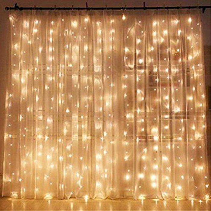 A curtain of string lights paired with a sheer fabric curtain