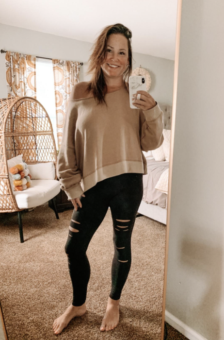 another reviewer styling the leggings with an off-the-shoulder sweater