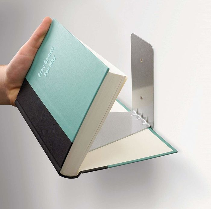 Demonstrating how the shelves are concealed within a partially opened book