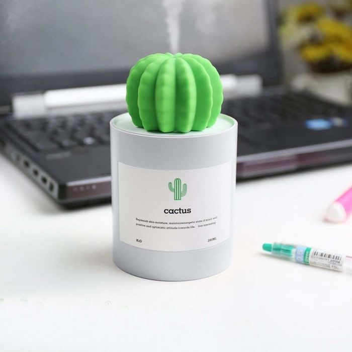 A cactus-shaped humidifier sitting on a desk.