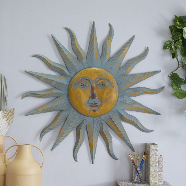 The metal sun art piece mounted on a wall