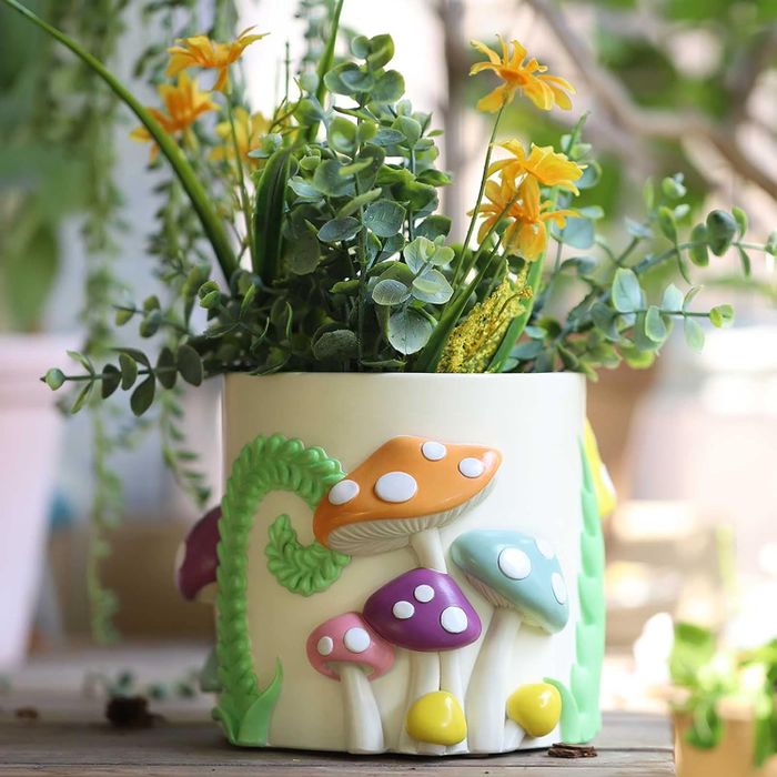A planter featuring a colorful mushroom design.