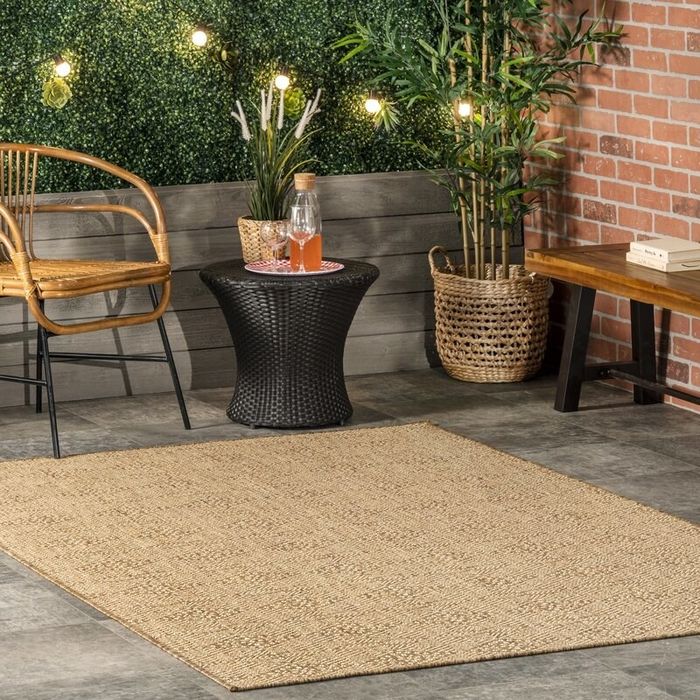 the brown geometric rug on the patio