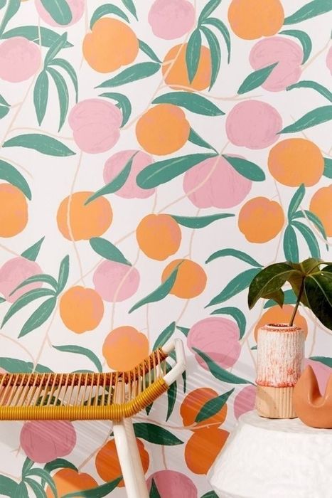 A room featuring peach-patterned wallpaper