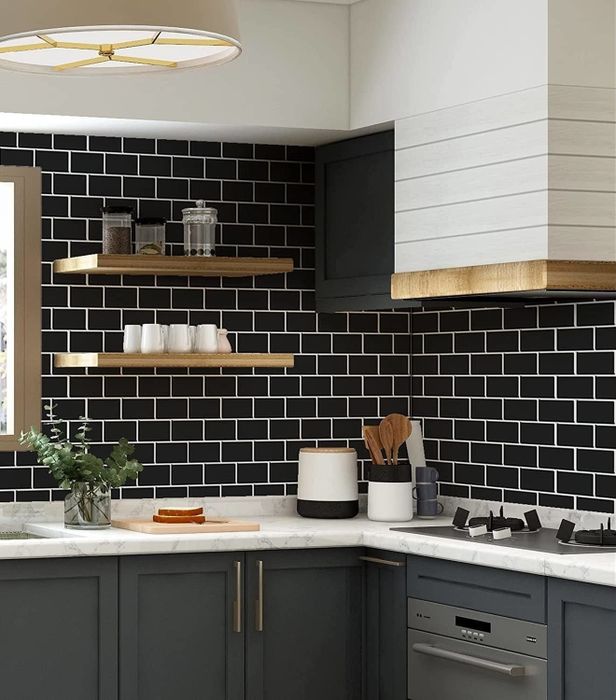 Black tiles installed on a kitchen wall