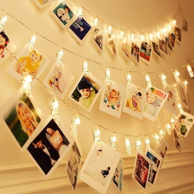 String lights with Polaroid photos attached using clips