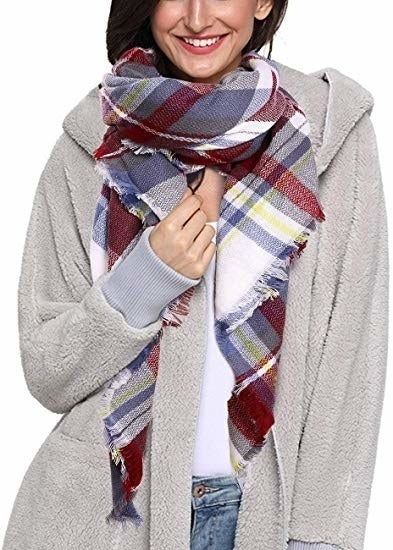 a model styling the scarf in a blue, red, and white pattern