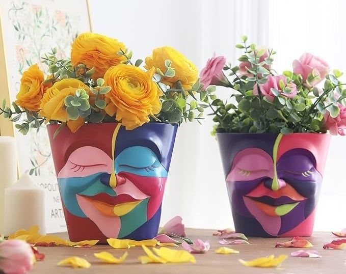Two vibrant face planters, each adorned with beautiful flowers