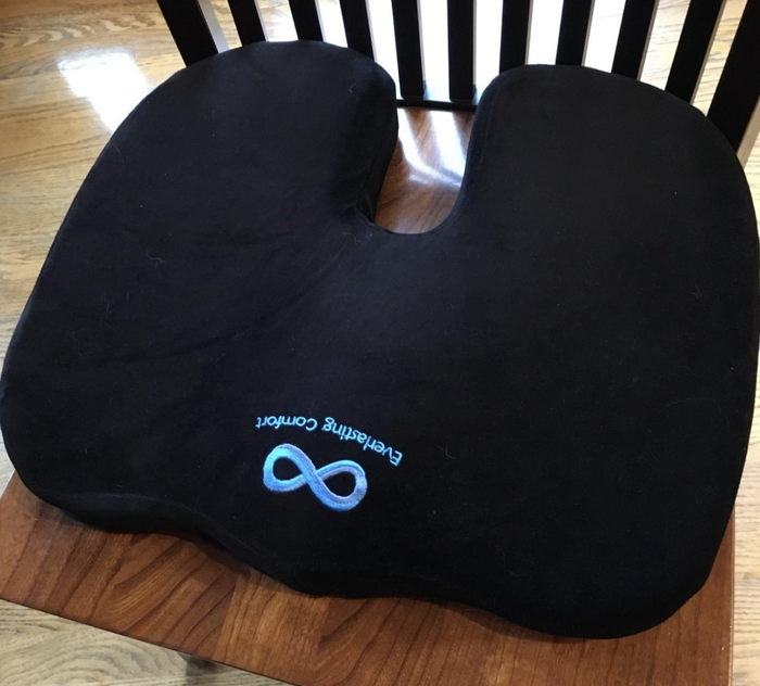 A customer review photo shows the cushion on their wooden chair.