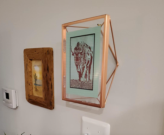 The copper wire frame mounted on a wall