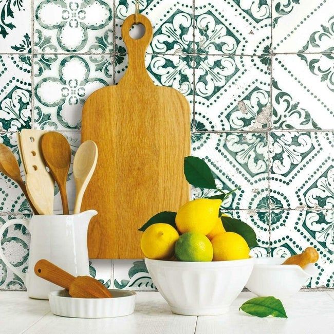 A faux aged tile design featuring a green floral motif