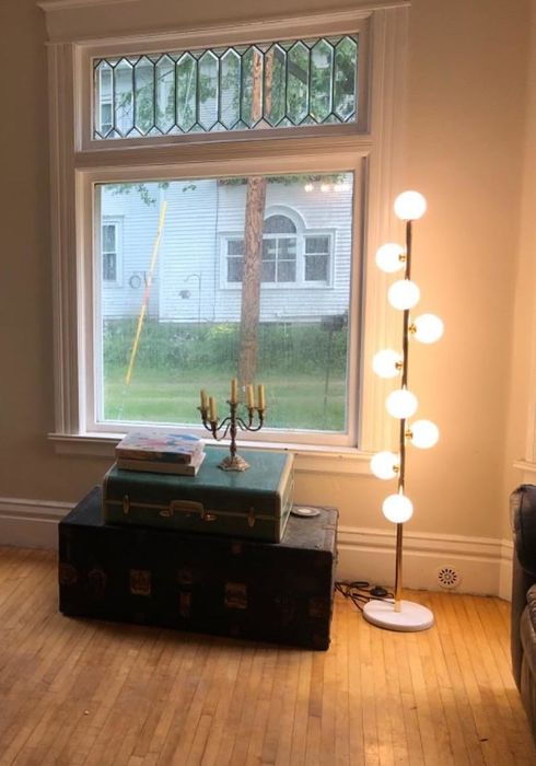 The same floor lamp from the reviewer's perspective, now turned on