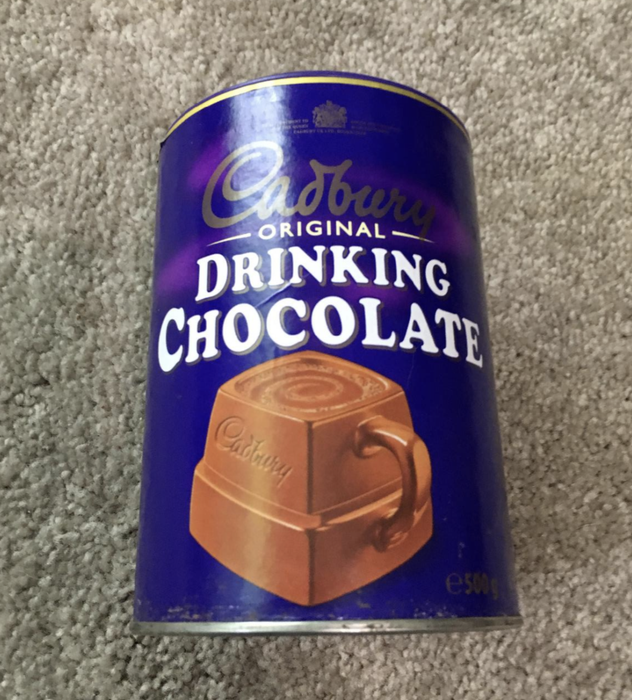 A customer review photo featuring the Cadbury drinking chocolate canister