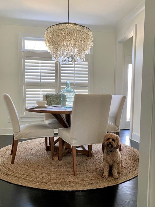 A reviewer's circular rug is displayed in their dining area