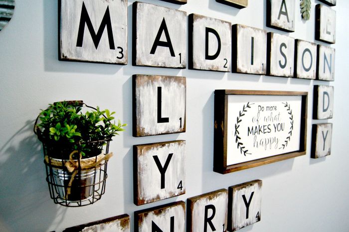 A wall adorned with large Scrabble-style tile squares as decorative art