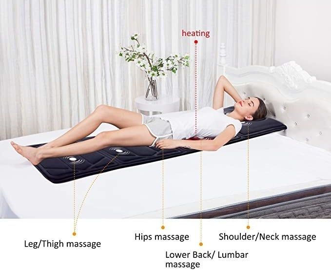 A person relaxing on the vibrating mat.