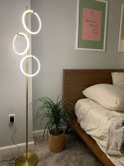 A reviewer's floor lamp is pictured in a bedroom setting