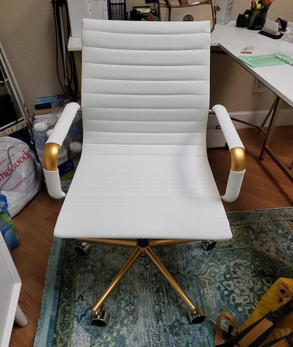 A close-up shot showing the front of the reviewer's rolling office chair