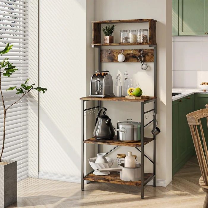 A baker's rack holding various kitchen appliances and other items, offering both style and functionality.