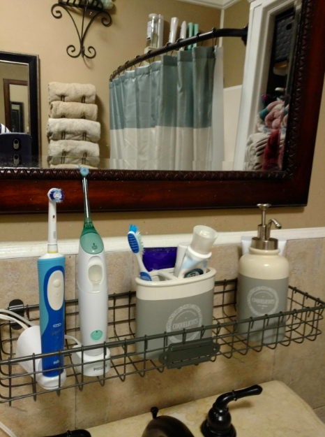 One of the baskets is mounted above a sink, neatly holding toothbrushes and soap.