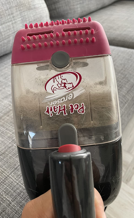 A reviewer proudly holding the vacuum.