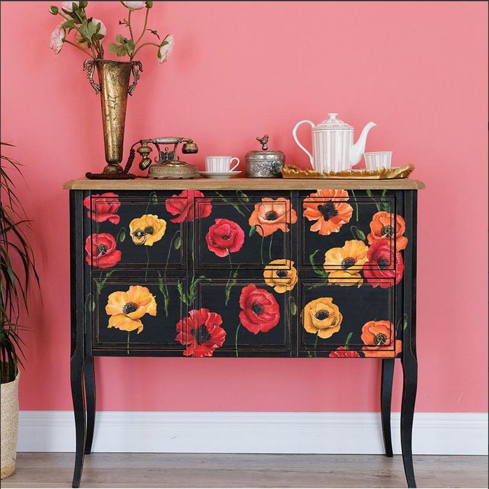 Black sideboard decorated with red, yellow, and orange illustrated poppy flower decals.