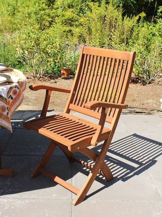 The chair positioned beside an outdoor table.