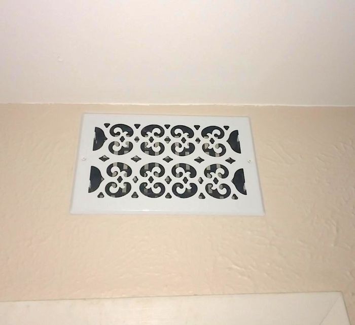 The air vent on the wall was covered with a metal grate that gives off a more feminine vibe compared to the standard builder-grade versions.