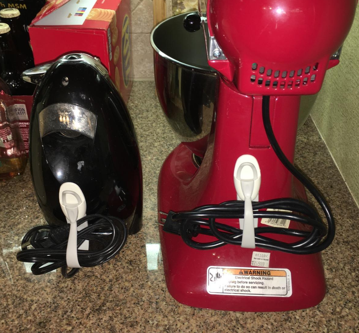 A reviewer's photo showing the cord bundlers attached to an iron and a stand mixer.