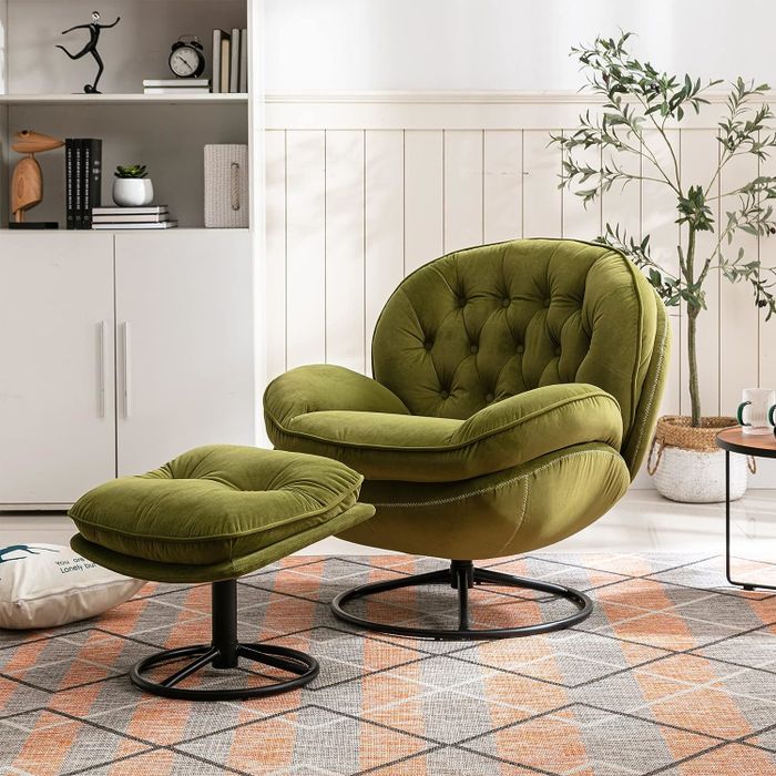 A luxurious green swivel chair paired with a matching ottoman, set in a cozy room