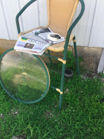 A reviewer's 'before' picture showing their old outdoor furniture, looking worn and outdated.