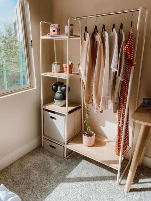 A reviewer's white garment rack with four shelves