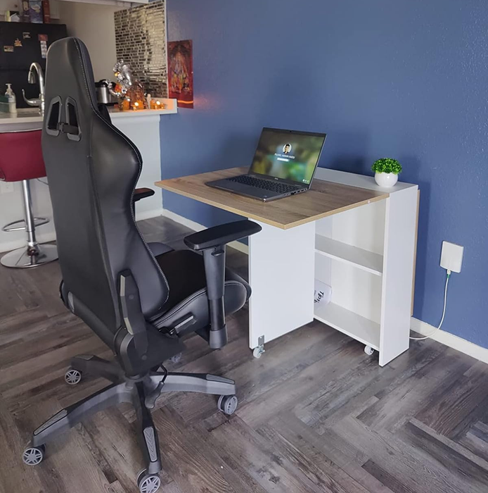 The same reviewer’s table with one side opened, and a computer chair added for use as a desk.