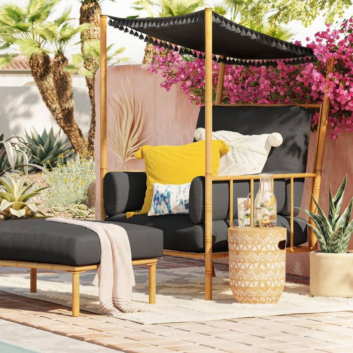 A black chair resting on a patio.