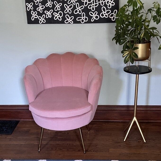 A pink barrel chair placed in a home setting