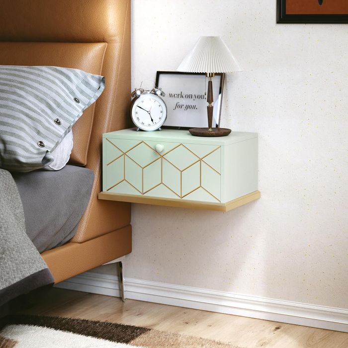 A bedroom scene showcasing a floating nightstand with a clock, lamp, and a framed print with the word 'LOVE.'