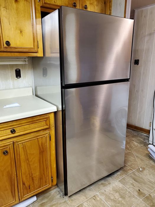 after: the same fridge, now transformed with contact paper to resemble stainless steel