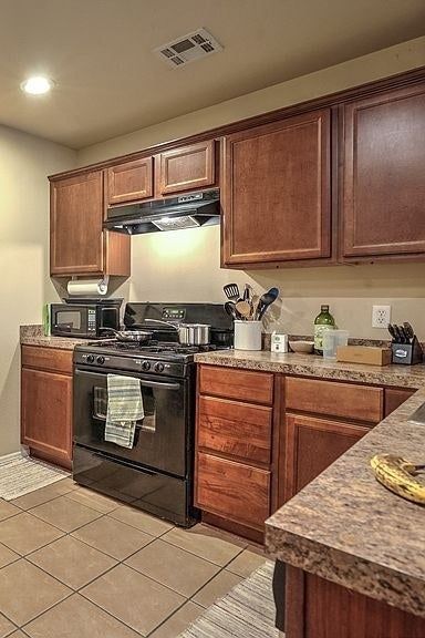 Before: Cabinets with a dark wood finish.