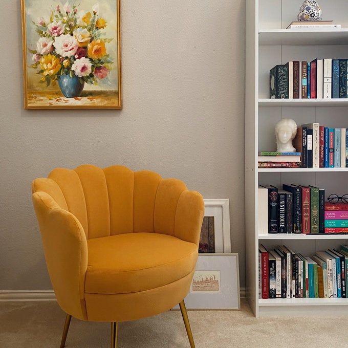 An orange shell-shaped barrel chair