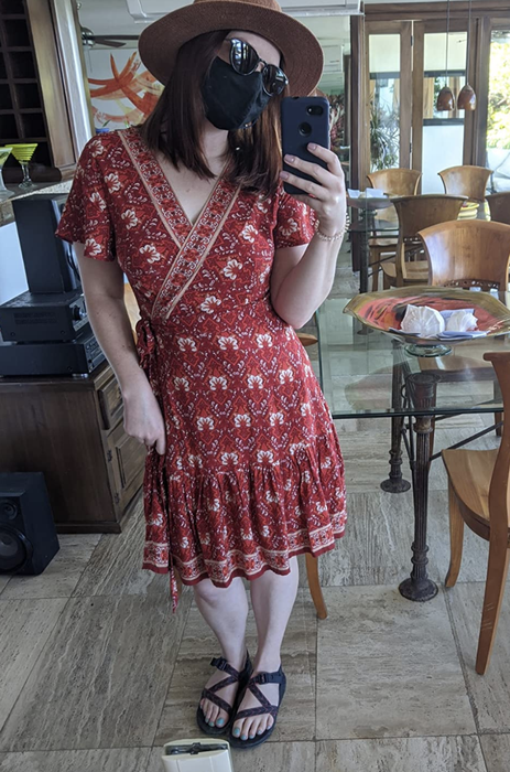 A reviewer in a red patterned dress