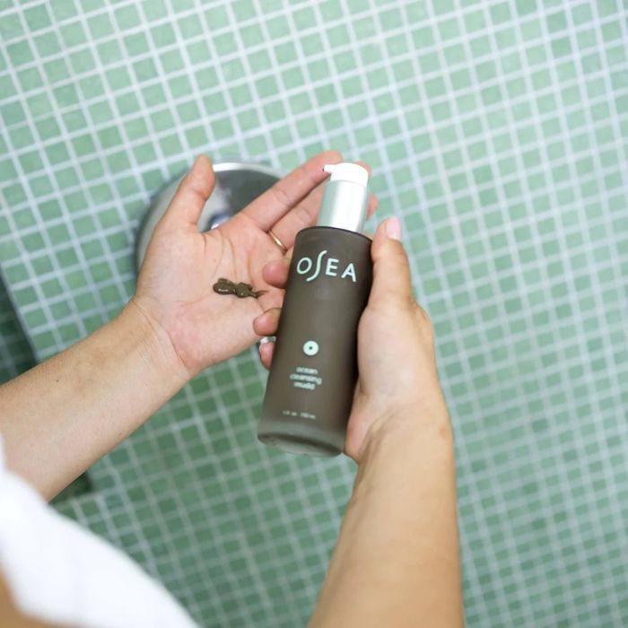 The cleanser held in a model's hand