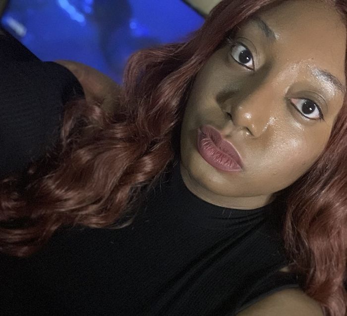 A reviewer applying the sunscreen to their skin.