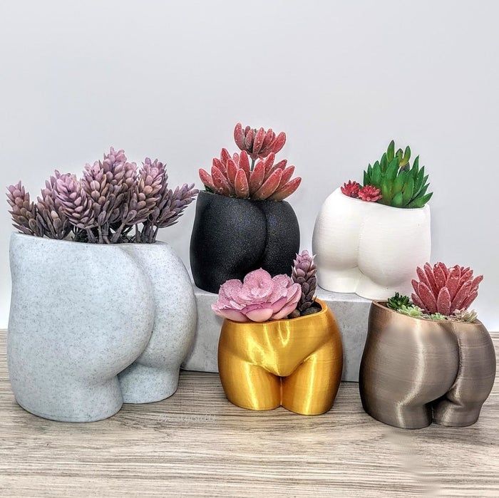 planters in various colors designed to resemble buttocks