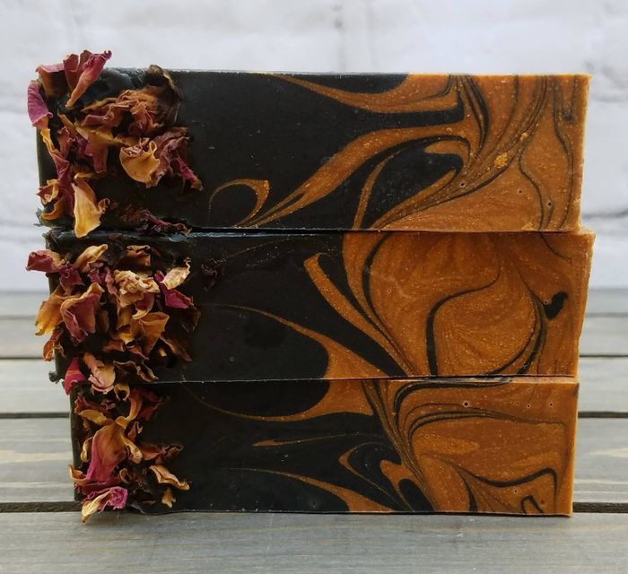 a stunning black and gold marbled soap with decorative dried flowers attached